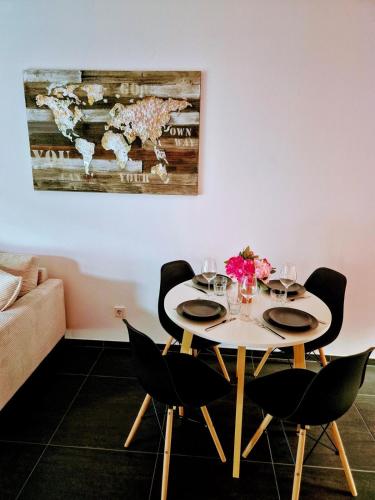 a dining room table with chairs and a painting on the wall at Stay atLinda's - Calm & peaceful in Eischen