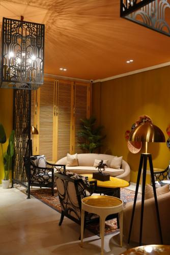 a living room with a couch and a table at The LC Hotel in Lahore