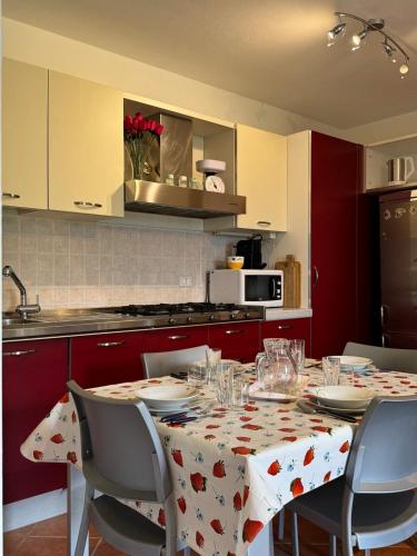 a kitchen with a table with a tablecloth with hearts on it at Summer Escape - Exclusive Chalet with private garden in Prada