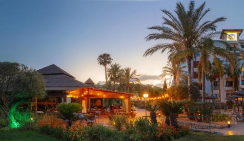 a resort with palm trees and a building at SH Villa Gadea in Altea