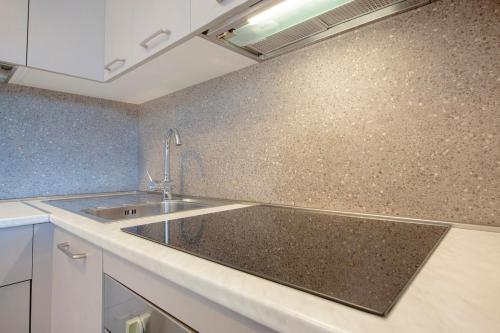 a kitchen with a sink and a counter top at Marlin Suite Apartment in Marina di Grosseto