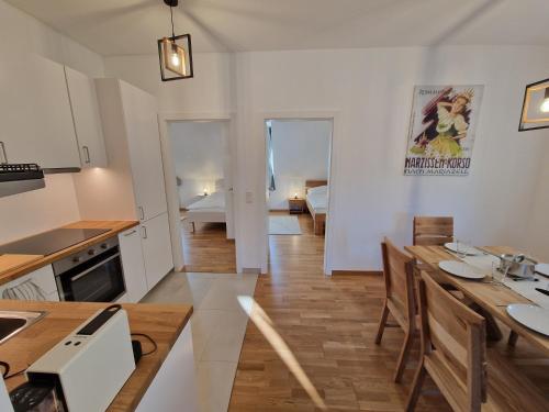 a kitchen and living room with a table and chairs at Mariazell Penthouse Kugeltreff in Mariazell