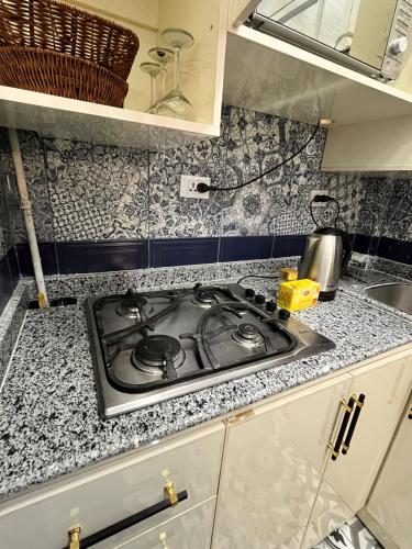 a kitchen counter with a stove top in a kitchen at charming studio in Cairo