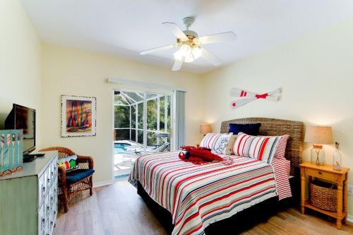 a bedroom with a bed and a ceiling fan at Beach Bliss in Bradenton