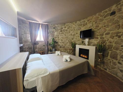 a bedroom with a bed and a fireplace at VILLA REGINA - Suite con Spa Sperlonga Vertice Rooms in Fondi