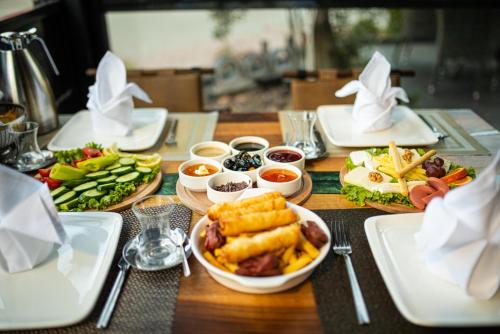 a wooden table with plates of food on it at ELİSA Park Hotel in Trabzon