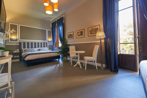 a bedroom with a bed and a table and chairs at My Guest in Florence in Florence