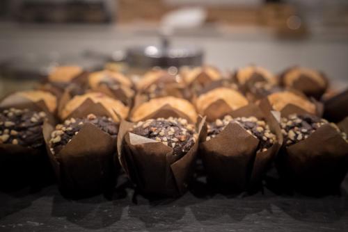 a group of chocolate covered donuts on a table at SH Ingles Boutique Hotel in Valencia