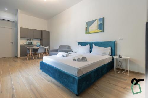 a bedroom with a large bed and a kitchen at Hotiday Torino Principi in Turin