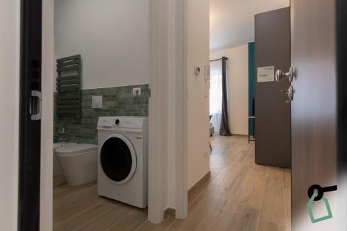 a bathroom with a washing machine in a room at Hotiday Torino Principi in Turin