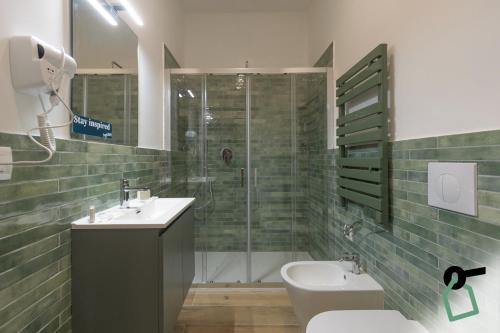 a bathroom with a shower and a sink and a toilet at Hotiday Torino Principi in Turin