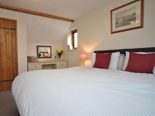 Rytonにある2 Bed in Shrewsbury 47795の大きな白いベッドと赤い枕のある寝室