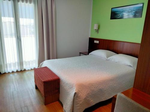 Ένα ή περισσότερα κρεβάτια σε δωμάτιο στο Alojamento Rivera