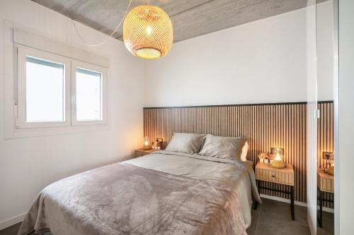a bedroom with a large bed and two windows at Villa Carlota in Garachico