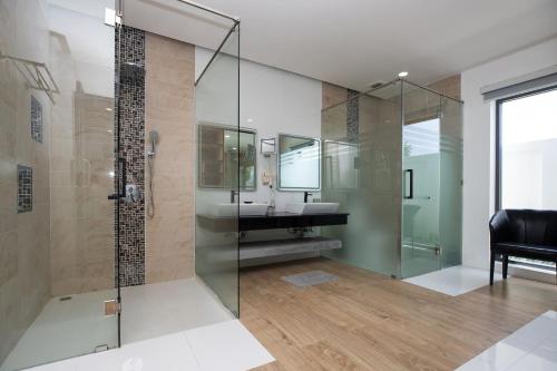 a bathroom with a glass shower and a sink at Villa Brianna Luxuria 2 - Rawai in Phuket Town