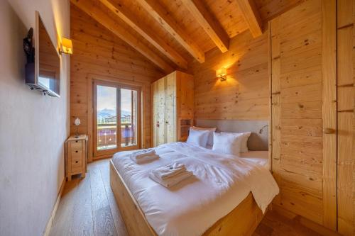 a bedroom with a bed in a wooden cabin at Montagnard 12 - spa access - car and careless holidays! in Nendaz