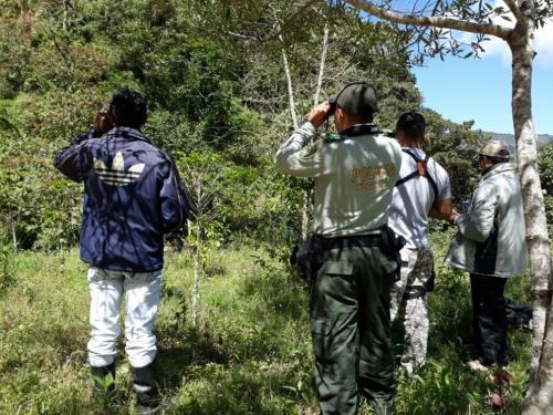 a group of men standing in a field taking pictures at Casa de Rishiva in San Agustín