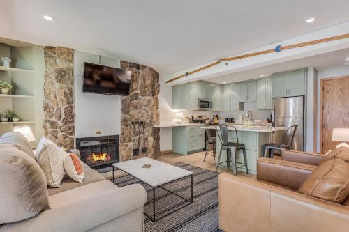 a living room with a couch and a fireplace at Laurelwood Condominiums 202 in Snowmass Village