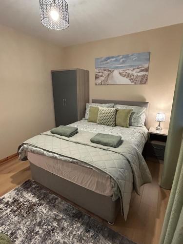 a bedroom with a large bed in a room at Port Panorama in Portstewart