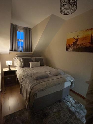 a bedroom with a bed and a window at Port Panorama in Portstewart
