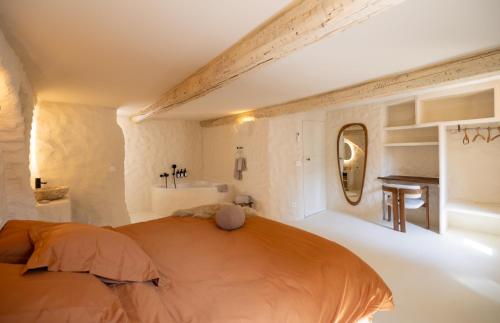 a bedroom with a large bed and a sink at CASA ANANTA Appartements bien-être aux portes du Verdon Refuge slow Life et sensoriel jusqu à 12 pers in La Garde