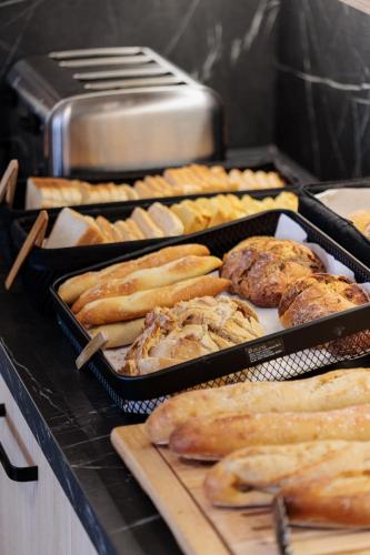 a bunch of trays of food on a counter at Residence du Parc - Val D'Europe in Montévrain