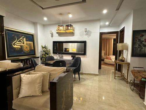 a living room with a couch and a desk in it at Air avenue luxury appartment phase 8 DHA lahore in Dargai