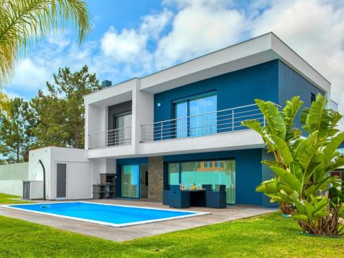 a blue house with a swimming pool at Vita Portucale ! Chic Luxe Villa with Saltwater Pool in Corroios