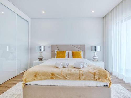 a bedroom with a large bed with two towels on it at Vita Portucale ! Chic Luxe Villa with Saltwater Pool in Corroios
