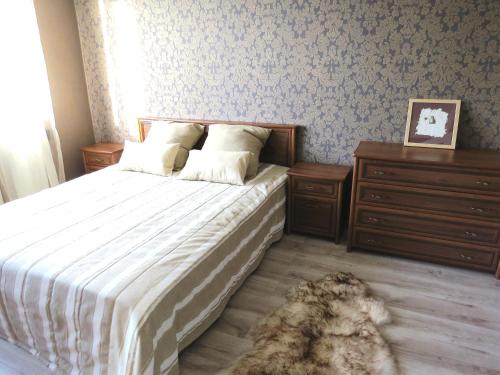 a bedroom with a bed and a dog laying on the floor at Apartement Endla in Pärnu