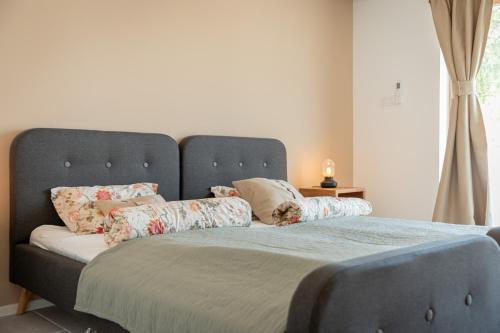 a large bed with pillows on it in a bedroom at Villa Mianka Rab in Banjol