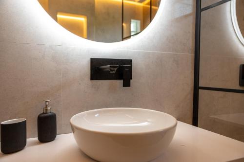 a bathroom with a white sink and a mirror at Villa Mianka Rab in Banjol