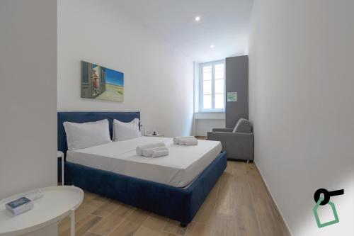 a small bedroom with a bed and a chair at Hotiday Torino Principi in Turin