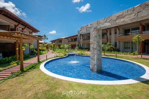 a swimming pool in front of a building at Apto Charmoso com Vista para Piscina! - BIO0079 in Camaçari