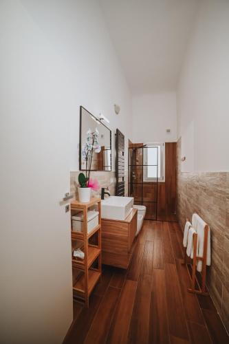 a bathroom with a tub and a sink and a mirror at Sami Twin Suite in Lecce