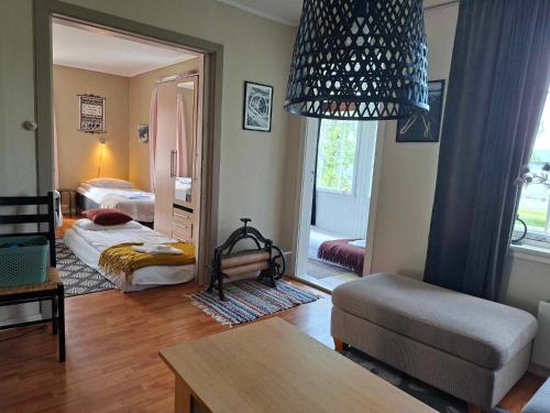 a room with a bedroom with a bed and a mirror at Privat leilighet på gård med badstue og nordlys in Narvik
