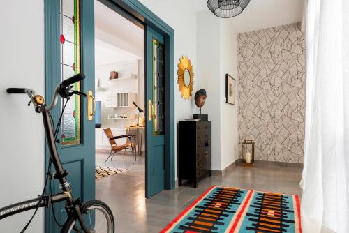 a room with a blue door and a bike in it at Genteel Home Albareda in Seville