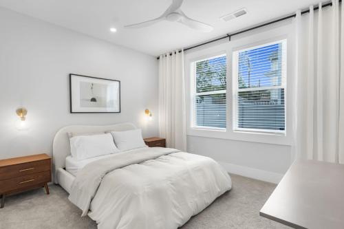 a white bedroom with a bed and a window at The Blackbrick Manor in Atlanta