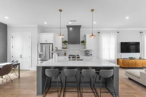 a kitchen with a large island with bar chairs at The Blackbrick Manor in Atlanta