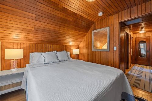 a bedroom with a bed in a wooden room at Life of Reilly - Scituate in Scituate