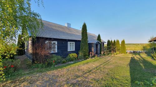 a house in the countryside with a yard at Authentic homestead over 100 years old in Kėdainiai