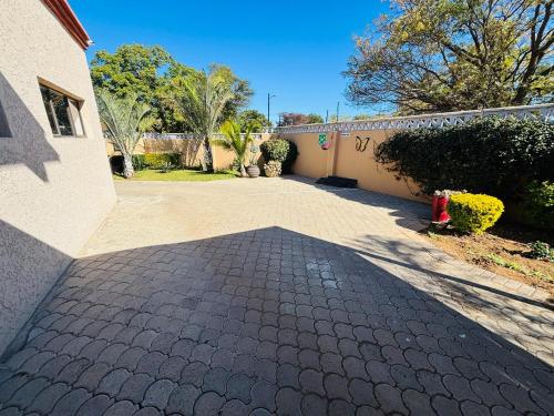 a brick driveway in front of a house at Dulelo Guest House Gaborone in Gaborone