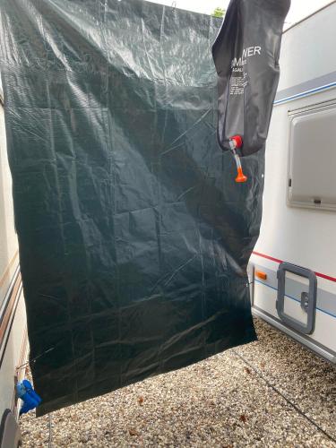 a black cover on the back of a camper trailer at BED & BREAKFAST 5 MIN FROM e47 - DOGS WELCOME - COSY FARM BnB in Tureby