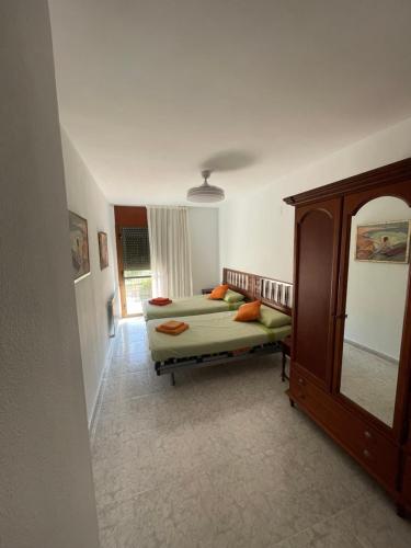 a bedroom with a bed and a dresser and a mirror at Luz de Ordesa in Boltaña
