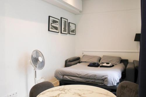 une chambre avec un lit, une table et des chaises dans l'établissement Nice Studio Near Eiffel Tower, à Paris
