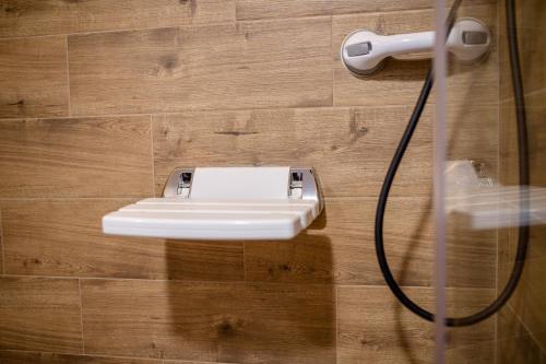 a bathroom with a white sink on a wooden wall at Gabriel Home in Rab