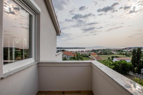 a balcony with a view of a city at Gabriel Home in Rab