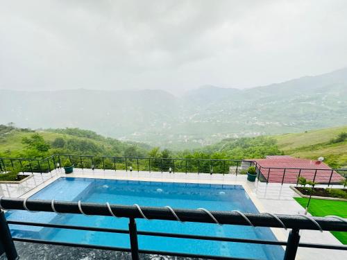 a swimming pool with a view of the mountains at Lemongarden in Akcaabat