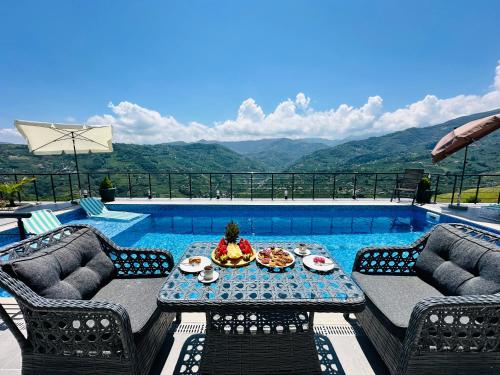 a table with food on it next to a swimming pool at Lemongarden in Akcaabat