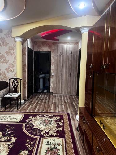 a room with a living room with a large rug at apartment shaxristan in Yunusobod